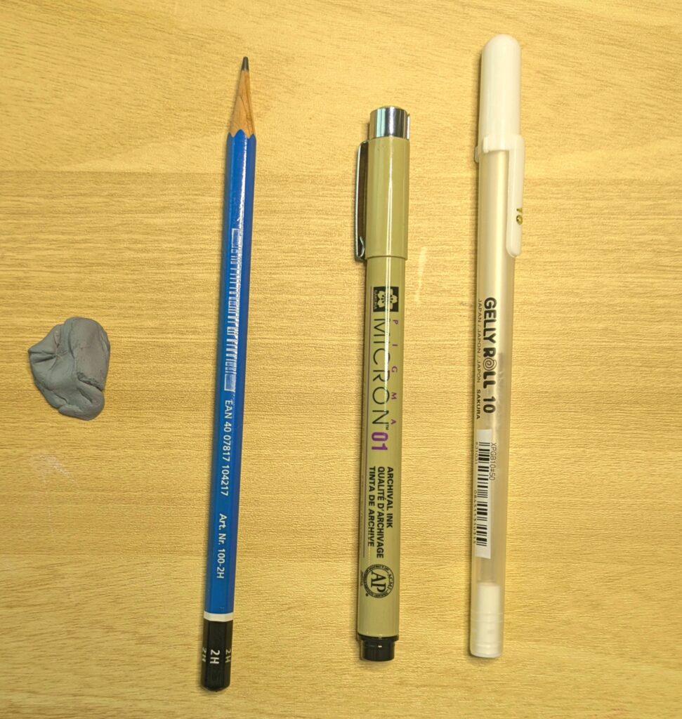 a piece of kneaded eraser, a pencil, a black fine liner and a white gel pen